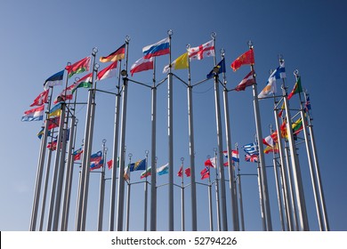 Europe Countries Flags Arranged In A Circle On Blue Sky. European Flags. European Union. German Flag.  French Flag. Italy Flag. Belgium Flag.Great Britain Flag. Spain Flag.Greece Flag. Ireland Flag.