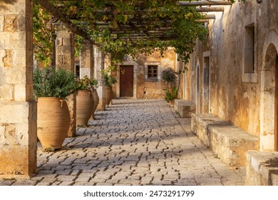 Europe, Greece, Crete, Rethymno. Venetian Baroque, 16th C. Eastern Orthodox Monastery. The Holy Monastery of Arkadi. Cloister with grape arbor.