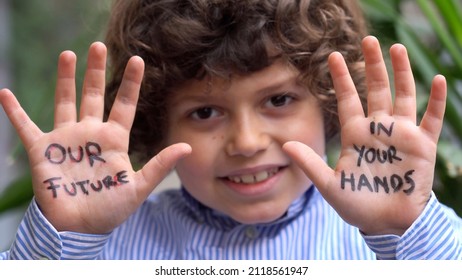 Europe, Italy - 7 Year Old Boy Child  Environmentalist With Written On His Hands Our Future Is In Your Hands - Environmentalist Protest Against Cmilmatic Changes And Global Warming - Youth For Future