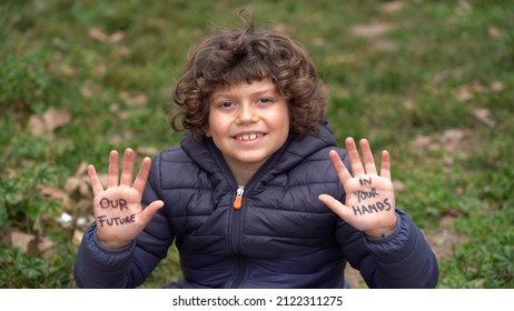 Europe, Italy - 7 Year Old Boy Child  Environmentalist With Written On His Hands Our Future Is In Your Hands - Environmentalist Protest Against Cmilmatic Changes And Global Warming - Youth For Future