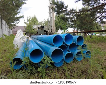 Europe, Kiev region, Ukraine - June 2021: Food pipes close-up. Drilling rig worker during work. The process of drilling a well for drinking water. Drilling water wells.