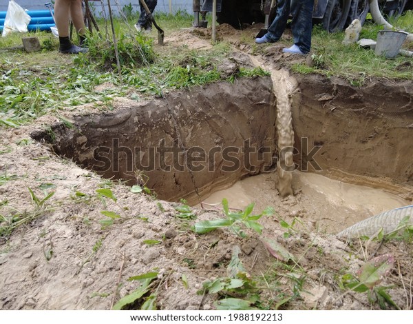 Europe,\
Kiev region, Ukraine - June 2021: An engineer is drilling a water\
well. Drilling rig worker during work. The process of drilling a\
well for drinking water. Water Well\
Drilling.