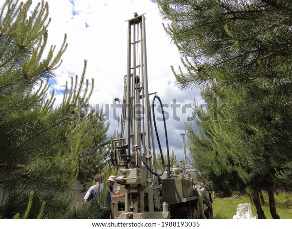 Europe,
Kiev region, Ukraine - June 2021: An engineer is drilling a water
well. Drilling rig worker during work. The process of drilling a
well for drinking water. Water Well
Drilling.