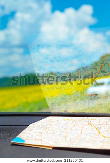 Europe road trip, map inside the car on dashboard,\
traveling around the world concept, summer adventures, vacation\
tour to Tuscany, Italy
