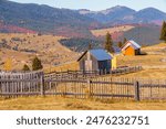 Europe, Romania, Transylvania, Carpathian Mountains.  Bucovina. Rural hay stacks in fields.