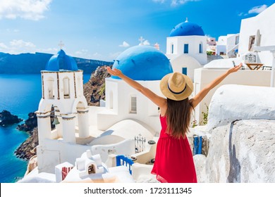 Europe Travel Happy Vacation Woman. Girl Tourist Having Fun With Open Arms In Freedom In Santorini Cruise Holiday, Summer European Destination. Red Dress And Hat Person.