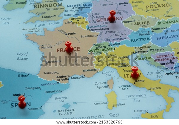 Europe travel route\
on map with red thumbtack, travel idea, France Germany Italy and\
Spain on map with red fastener, vacation and road trip concept,\
europe destination, top\
view