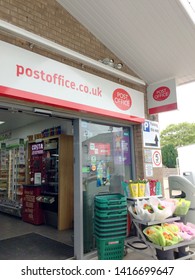 Europe UK Lincolnshire Alford May 2019. Glass Window Shop Front For Post Office. Small Grocery Store. Flowers And Shopping Baskets Outside. Advertising Signs. Security Camera.