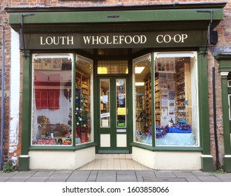 EUROPE UK LINCOLNSHIRE LOUTH 30th DECEMBER 2019. Green And White Painted Shop Front With Windows. Old Building. Central Door. Independent Health Food Store.