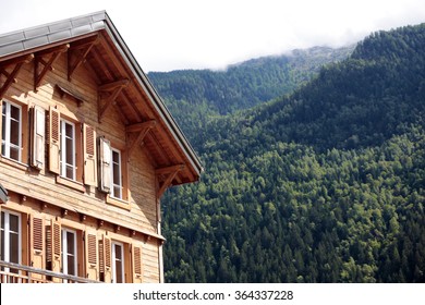 European Alpine Ski Chalet Small Hotel, Alps Mountains In The Distance.  