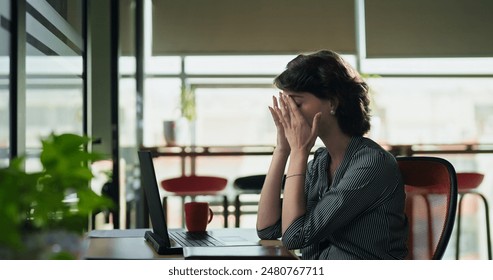 European angry tired woman sitting on chair use laptop talking shouting online video call indoor job office. Caucasian sad upset young adult female corporate distant quarrel feel head ache work place - Powered by Shutterstock