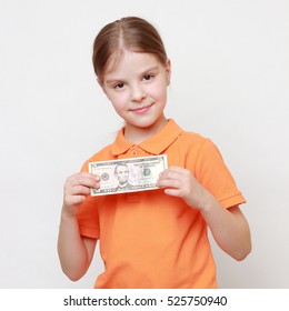 European beautiful little girl holding dollars