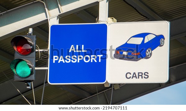 European border crossing sign with green\
traffic light. Customs checkpoint for cars. Passport verification\
and document inspection at border\
crossing.