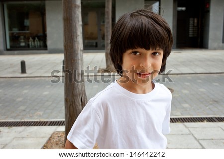 Similar – Image, Stock Photo Brown-haired boy with an athletic physique on an athletic oval massages his muscles with a foam roller for better recovery. Post-workout