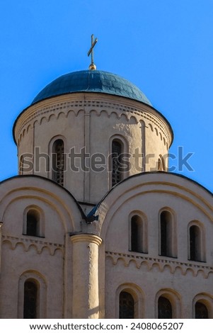 It is European christian church. It is  close up view of church in sunny  midday. There is golden cross on church dome.