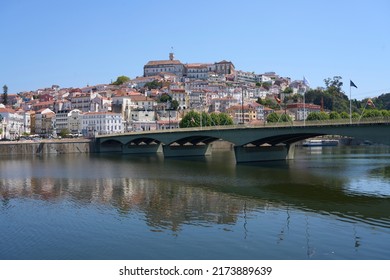 European Coimbra city and Santa Clara bridge over Mondego river at Central district in Portugal, clear blue sky in 2022 warm sunny spring day on May. - Shutterstock ID 2173889639