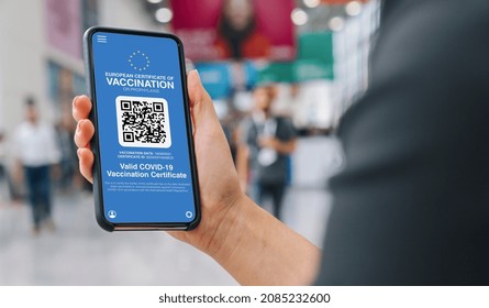 European Covid Pass Certificate of immunity against Covid19 on a mobile phone. Close up of woman holding a smartphone screen application certicy that have been vaccinated of coronavirus. Medical App