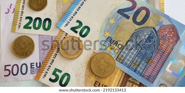 European currency background. Banknotes two hundred\
euros, one hundred euros, fifty euros, twenty euros and coins.\
Money background. 