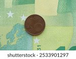 European currency euro cent coin lies on euro banknote bill close up