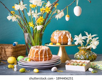 European Easter with traditional decoration eggs, daffodils and Easter cake