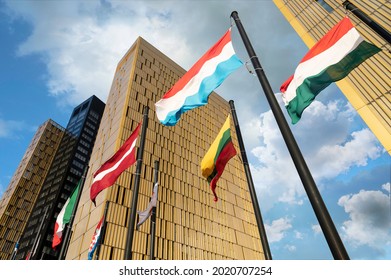European Flags flapping in the wind, in front of European Union Court of Justice building in Luxembourg Kirchberg. Flags of Luxembourg, Hungary, Lithuania, Austria...