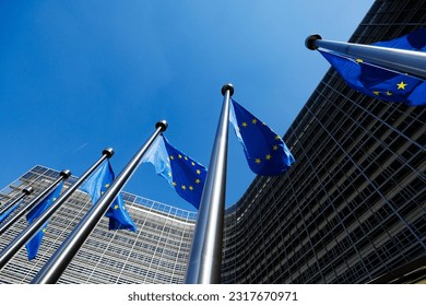 European flags in front of the Berlaymont building, headquarters of the European Commission in Brussels, Belgium