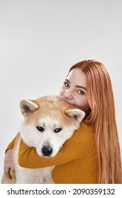 European Girl Caressing Shiba Inu Dog In White Studio. Closeness, Concept Of Relationship Between Human And Animal. Idea Of Owner And Pet Friendship. Young Woman And Dog Looking At Camera. Copy Space