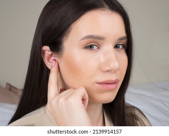 European Girl Getting Ready For Bed. Earplugs In The Ear Will Provide Peace And Quiet All Night Long.