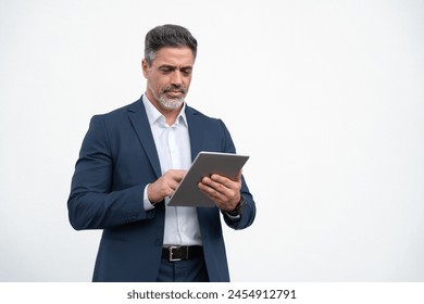 European Hispanic successful mature adult professional business man in formal suit working on device. Indian senior businessman ceo holding digital tablet using application isolated, white background - Powered by Shutterstock