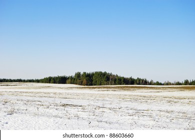 European Landscape In March: On Fields Snow Starts To Thaw