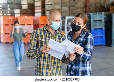 European Male And Female Employee With Masks Working At The Warehouse