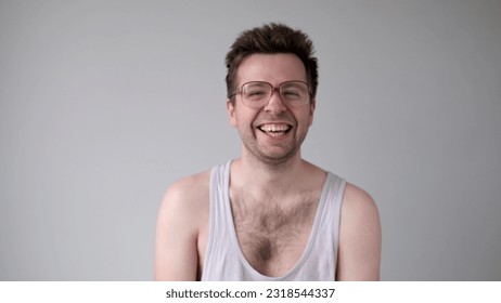 European man with big glasses is laughing foolishly. - Shutterstock ID 2318544337