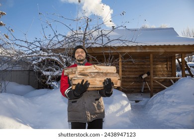 A European man carries firewood to the bathhouse. - Powered by Shutterstock