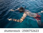 European man snorkeling in the sea. Brunette guy with mask and snorkel for swimming. Diving on vacation