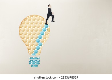 European man in suit standing on abstract pattern light bulb on light background with mock up place. Idea, growth and success concept