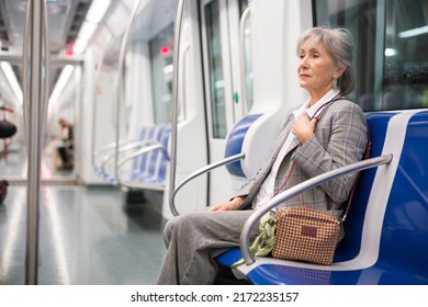 European Mature Woman Sitting In Subway Train And Waiting For Her Stop..