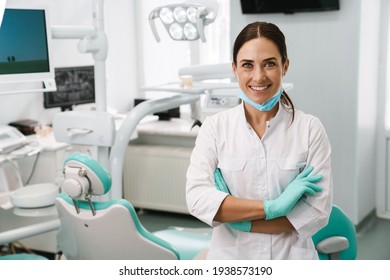European mid dentist woman smiling while standing in dental clinic - Shutterstock ID 1938573190