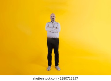 European middle aged man, full size body shot of European middle aged man. Standing isolated yellow background. Copy space. Confident caucasian male. Standing, arms crossed, smiling father. - Shutterstock ID 2280712357