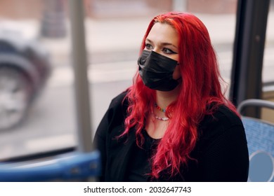 European plus size woman face mask riding bus transport. Young red pink haired body positive girl with facemask - Powered by Shutterstock