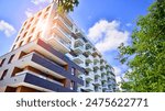 European residential architecture harmonizing with nature. Eco-friendly living in city with greens. Eco apartment building saving energy and fresh air concept. 