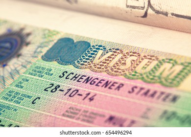 European Schengen zone visa in passport - close up. Filtered image: cross processed vintage effect. - Shutterstock ID 654496294