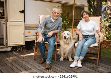 European senior family old couple spouses husband and wife relaxing on the beach chairs with dog golden retriever, traveling on holidays with domestic animals pets - Powered by Shutterstock