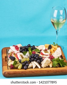 
European Snack. Champagne With Fruit Plate, Berries, And Cheese. Black And Green Grapes, Cheese Platter, Red And Black Currants, Mint, Lingonberries.