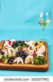 
European Snack. Champagne With Fruit Plate, Berries, And Cheese. Black And Green Grapes, Cheese Platter, Red And Black Currants, Mint, Lingonberries.