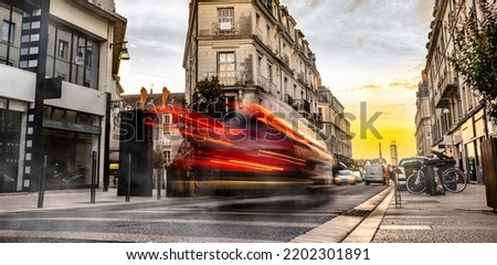 European street with car trails in the evening. Beautiful evening lights in city,