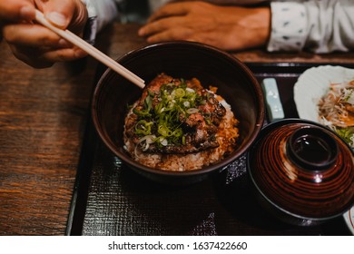 
European Tourist Eating Asian Food In Tokyo, Japan. Trying New Flavors During Her Trip. Close Up. Lifestyle