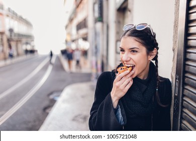 European Tourist Woman Trying Out Local Food.Eating Traditional Portuguese Egg Custard Tart Pastry Dessert Pastel De Nata.