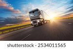 European truck driving on the asphalt road in rural landscape at sunset. Transportation and cargo concept.