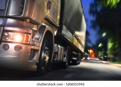 European Type Truck With Turn On Headlights In Night City