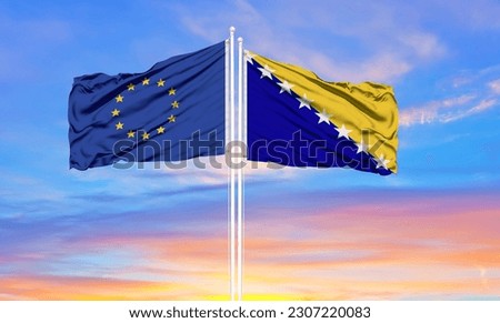 European Union and Bosnia and Herzegovina two flags on flagpoles and blue cloudy sky . Diplomacy concept, international relations